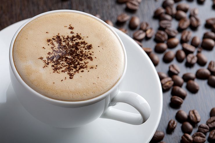 Cappuccino in white cup on a saucer