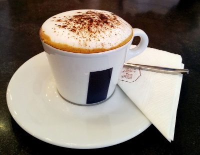 cappuccino in a porcelain cup with saucer