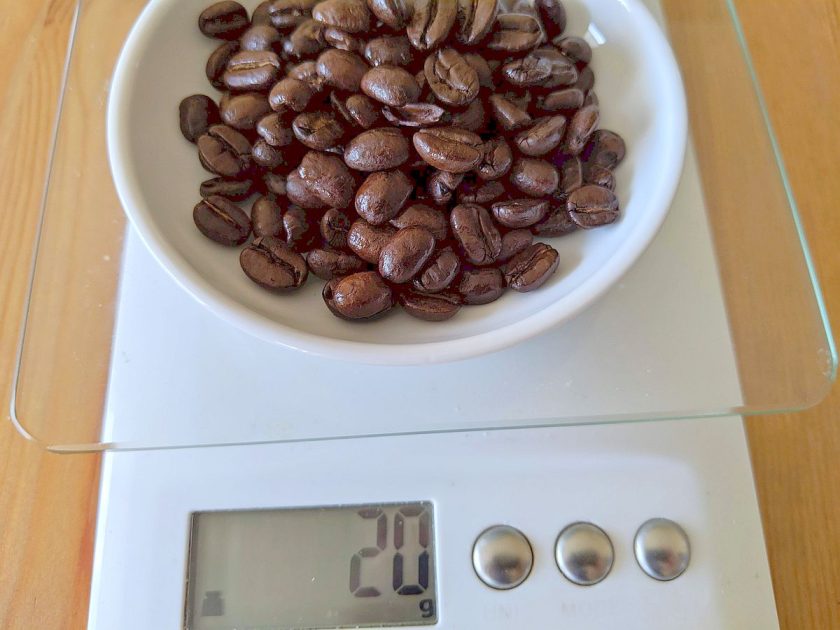 weighing coffee beans on kitchen scale