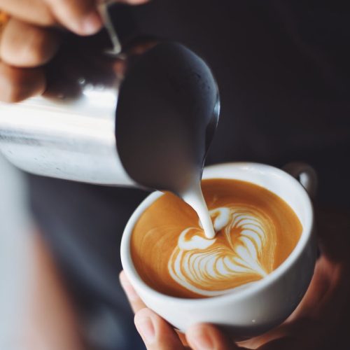 Pouring wet cappuccino with latte art