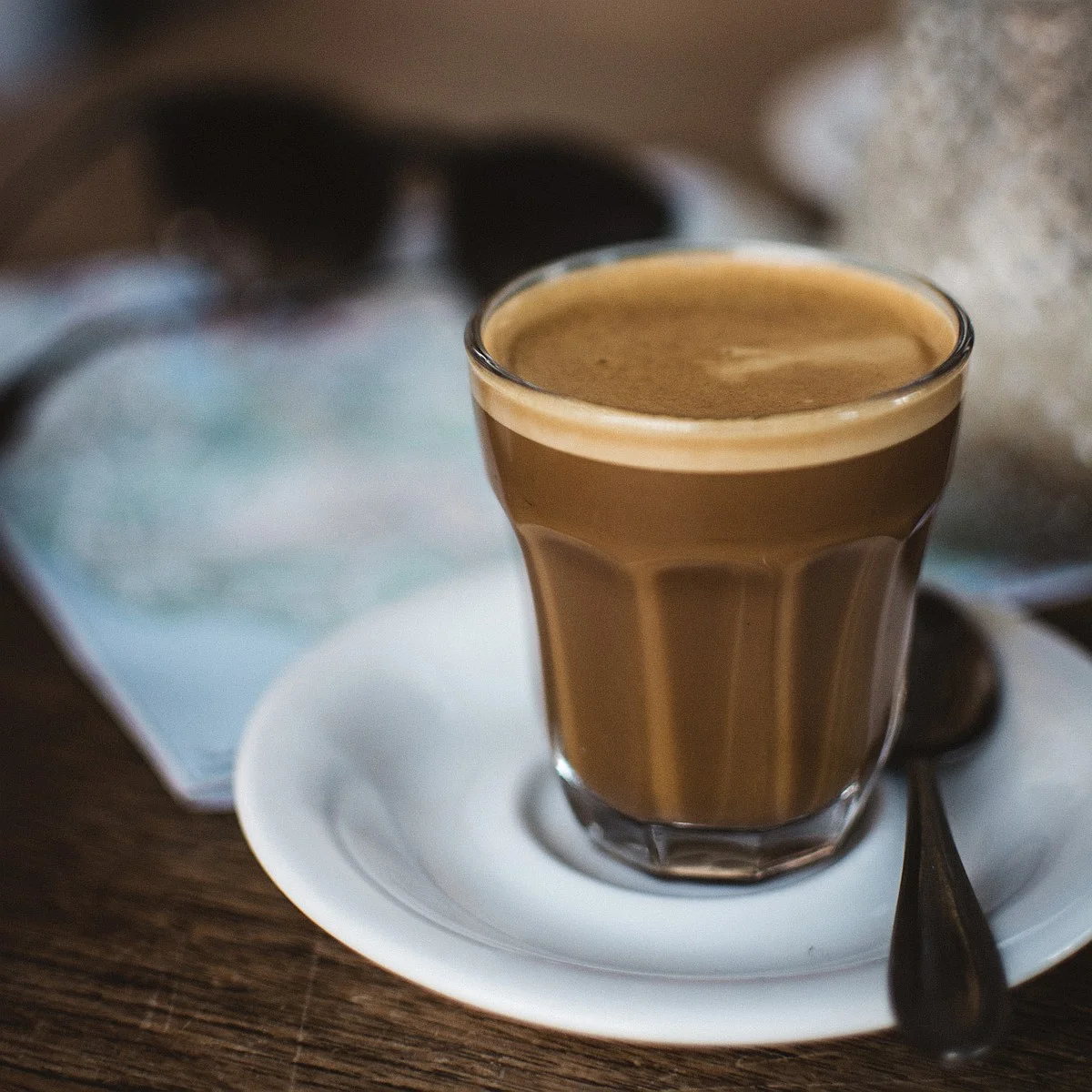 Cortado coffee in glass on a white saucer