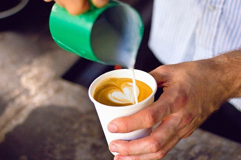 barista pouring latte