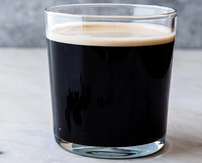 frothy cold brew nitro coffee with beans ready to drink.