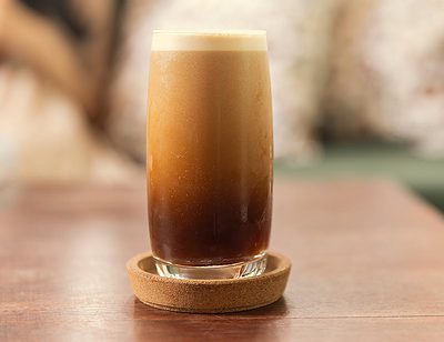 cold brew espresso nitro coffee drink in a glass with a consistent foam