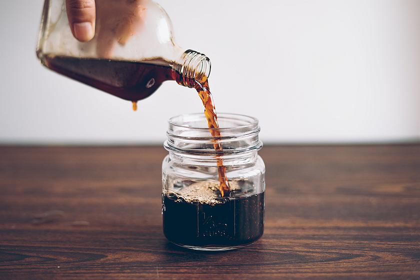 pouring cold brew coffee in jar