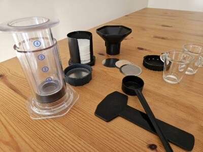 AeroPress coffee maker kit including after market metallic filter and custom filter cap.