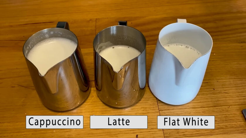Three milk pitchers labeled Cappuccino, Latte, Flat White